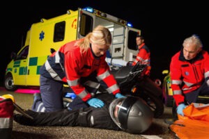 Paramedical team assisting an injured motorcycle rider