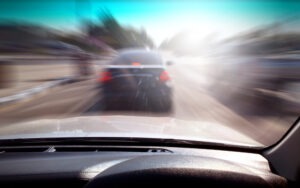 a blurred image of a car speeding on the highway from the driver's point of view