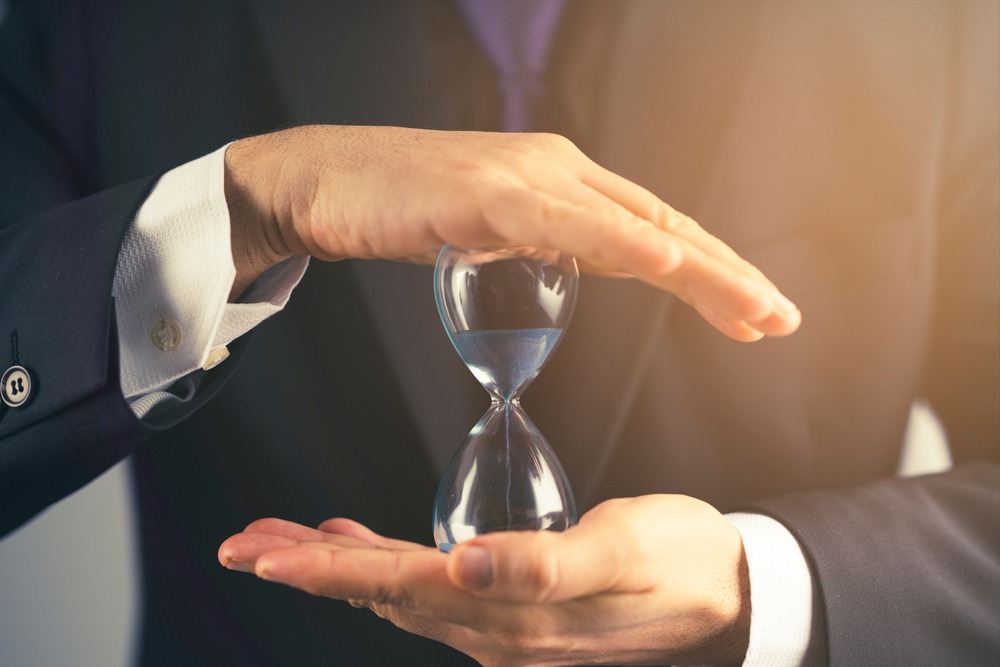 Personal injury lawyer holding an hourglass symbolizing Virginia's Statute of Limitations.