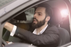 A driver is yelling at a negligent motorist who is about to cause a severe collision. A lawyer can review your options for additional compensation if the car accident claim exceeds insurance limits.